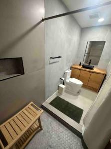 een badkamer met een toilet, een wastafel en een spiegel bij Spacious 5BR Oasis with Heated Pool - Perfect for Family in Mesa
