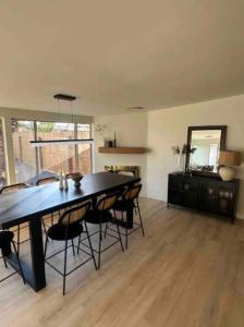 a dining room with a black table and chairs at Spacious 5BR Oasis with Heated Pool - Perfect for Family in Mesa