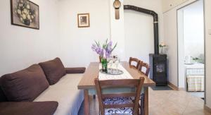 a living room with a couch and a table at Holiday house with a parking space Zrnovnica, Split - 22688 in Žrnovnica