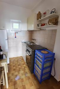 a small kitchen with a sink and a stove at Holiday house with a parking space Bibinje, Zadar - 22783 in Bibinje