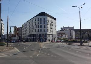 a large white building on a city street at Old Town modern apartment by Kovee in Bratislava