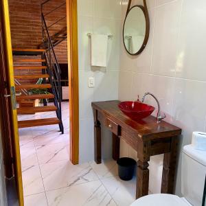 a bathroom with a red sink and a staircase at Villetta Gramado Siena in Gramado +19 photos