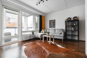 a living room with a couch and a table at City flat with a sauna & balcony in Helsinki