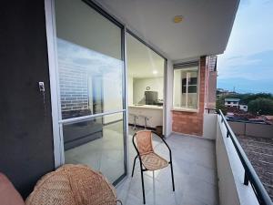a chair sitting on a balcony with a view at ¡Vista Increíble Apartamento Tamarindo! in Santa Fe de Antioquia