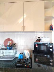 a kitchen with a microwave and a counter top at Silverpart Resort Fraser Hill C3-6-1 Forest View High Floor No lift in Bukit Fraser