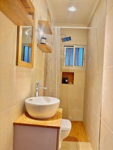 a bathroom with a sink and a toilet at Chez Maëlys in Douala +12 photos