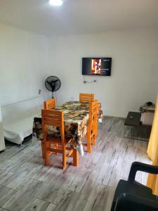 une salle à manger avec une table, des chaises et une télévision dans l'établissement Casa quinta , ideal descanso, 