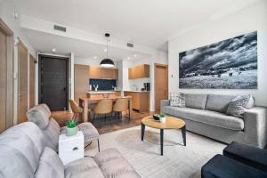 a living room with a couch and a table at The Nomad Saint Jacques in Montréal