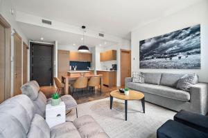 a living room with a couch and a table at The Nomad Saint Jacques in Montréal +214 photos