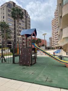 a playground with a slide in a park at Apartment Bahia del Sol, a 20 m de Playa Arinal-Bol,Calpe in Calpe