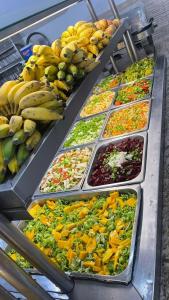 a buffet line with different types of fruits and vegetables at POUSADA BRASÃO in Governador Valadares