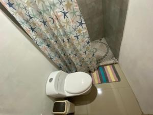 a bathroom with a toilet with stars on the wall at The Sloth Retreat & Studio Fortuna in Fortuna