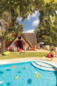 a swimming pool with toys in front of a house at Reid's Palace, A Belmond Hotel, Madeira in Funchal