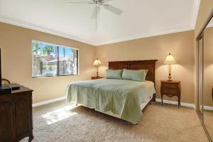 a bedroom with a bed and a window at VB944 - Triple Fairway View - Palm Valley CC in Palm Desert