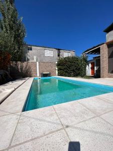 a swimming pool in front of a house at Tu rincón la travesia in Las Compuertas