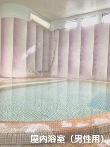 a swimming pool with water in a building at Izuya Ryokan - Vacation STAY 22369v in Yugawara