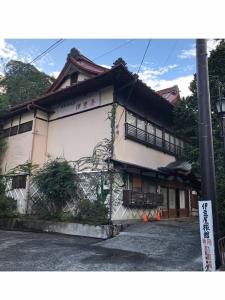 a building with an asian writing on the side of it at Izuya Ryokan - Vacation STAY 22369v in Yugawara