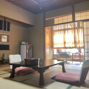 a living room with a table and chairs at Izuya Ryokan - Vacation STAY 87162v in Miyakami