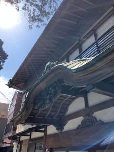 a building with a balcony on top of it at Izuya Ryokan - Vacation STAY 87162v in Miyakami +6 photos
