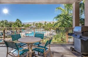 a balcony with a table and chairs and a grill at Worldmark Indio in Indio