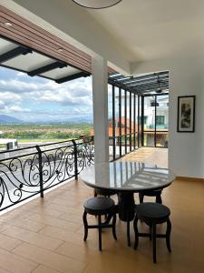 a table and chairs on a balcony with a view at Peak Homestay@Ipoh Perak Malaysia 10-14Pax 5R/6B in Lahat