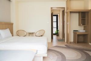 Rúm í herbergi á 海角瑞拉斯包棟民宿- Cape Relax Villa