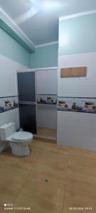 a bathroom with a toilet and a counter with food at casa sol residencial in Tarapoto
