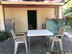 a table and two chairs in front of a house at CABINA EL MANU in Golfito