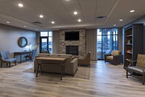 a waiting room with a couch and a fireplace at Fairfield Inn & Suites by Marriott Colorado Springs East in Colorado Springs