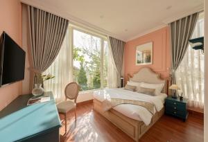 a bedroom with a bed and a large window at D HOUSE DALAT 2 in Da Lat