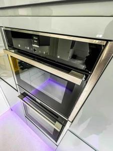 a microwave oven sitting on top of a counter at Luxury Apartment London in London