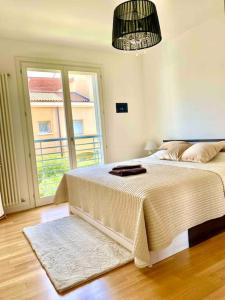 ein Schlafzimmer mit einem Bett und einem großen Fenster in der Unterkunft Luxury Apartment Centre. Pool. Beach and Shopping in Lido di Jesolo