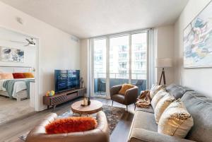 a living room with a couch and a tv at Luxury- 2BR in Channel Side - downtown Tampa in Tampa