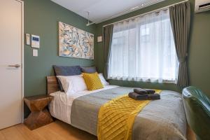Ein Bett oder Betten in einem Zimmer der Unterkunft Felice Nishi-Shinjuku