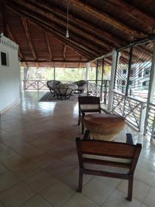 a room with benches and a table in a building at Mkuu House in Malindi