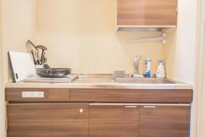 a kitchen with a sink and a counter top at Walk to Ikebukuro Station. SoL3 in Tokyo