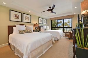 a bedroom with two beds and a ceiling fan at Kaanapali Alii 456 in Kaanapali