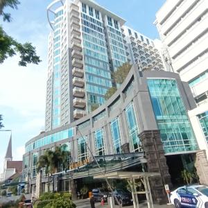 a tall building with a bridge in front of it at eL Royale Apartment by Faris Property in Bandung