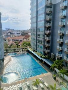 a view from the balcony of a building with a swimming pool at eL Royale Apartment by Faris Property in Bandung