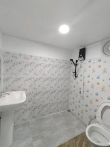 a bathroom with a toilet and a sink at Lsarl Pool Villa อิฏฐ์สรี พูลวิลล่า in Wangkata