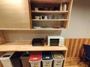 a kitchen with a counter with a microwave and a stove at Long Stay Takayama in Takayama