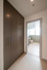 a bathroom with wooden cabinets and a toilet at 3 Bedrooms Forte tower 1- Downtown Skylight in Dubai