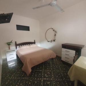 a bedroom with a bed and a mirror and a table at HOSTAL BOLIVIA EN YACUIBA in Yacuiba