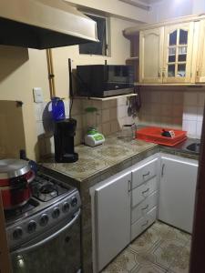 a kitchen with a stove and a microwave at Mi casa tu casa. My house in La Paz