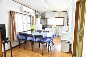 a kitchen with a table and chairs in a room at Greenheim Suitengushita / Vacation STAY 1689 in Otaru