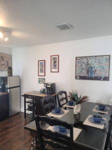 a dining room with a table and a refrigerator at Contemporary California Bungalow in Brea