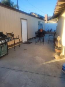 an empty patio with chairs and a table and a table at Contemporary California Bungalow in Brea