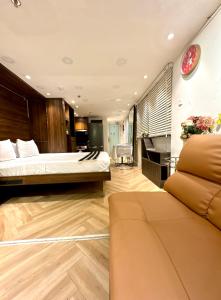 a hotel room with a bed and a couch at Toi's Travel Home Central in Ho Chi Minh City