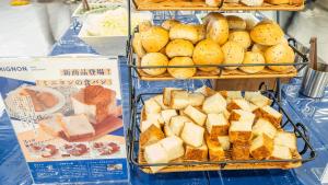 a display of bread and other foods on a table at Toyoko Inn Kokura-eki Kita-guchi in Kitakyushu