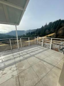 a large deck with a view of the mountains at Beau duplex vue sur le Lac Blanc in Orbey